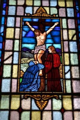 up close stain glass of jesus on the cross in the church sanctuary